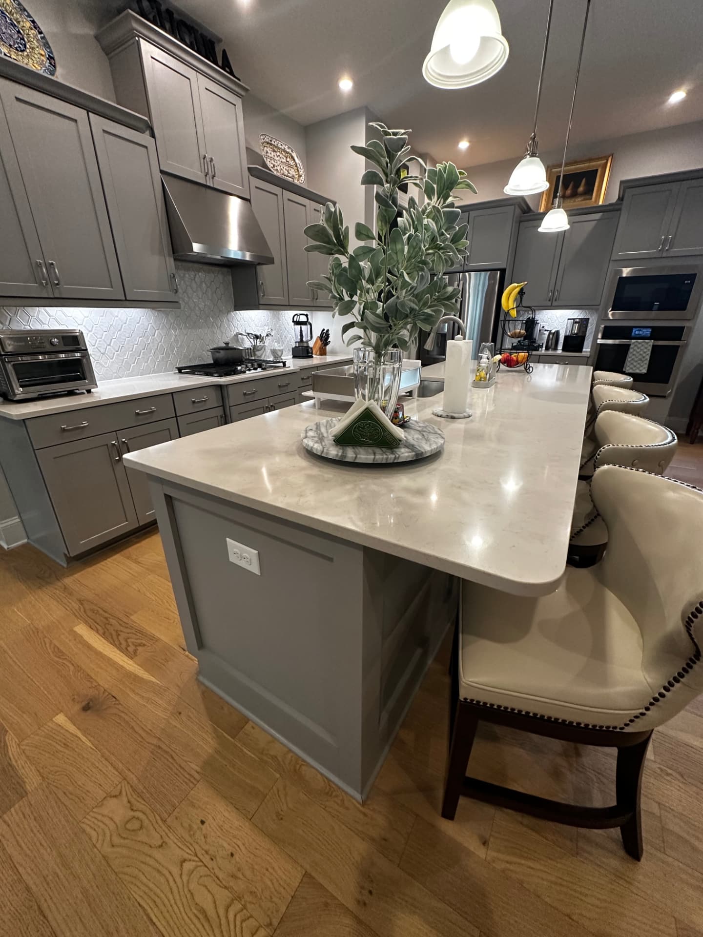 Kitchen with a polished quartz island and spotless countertops after cleaning